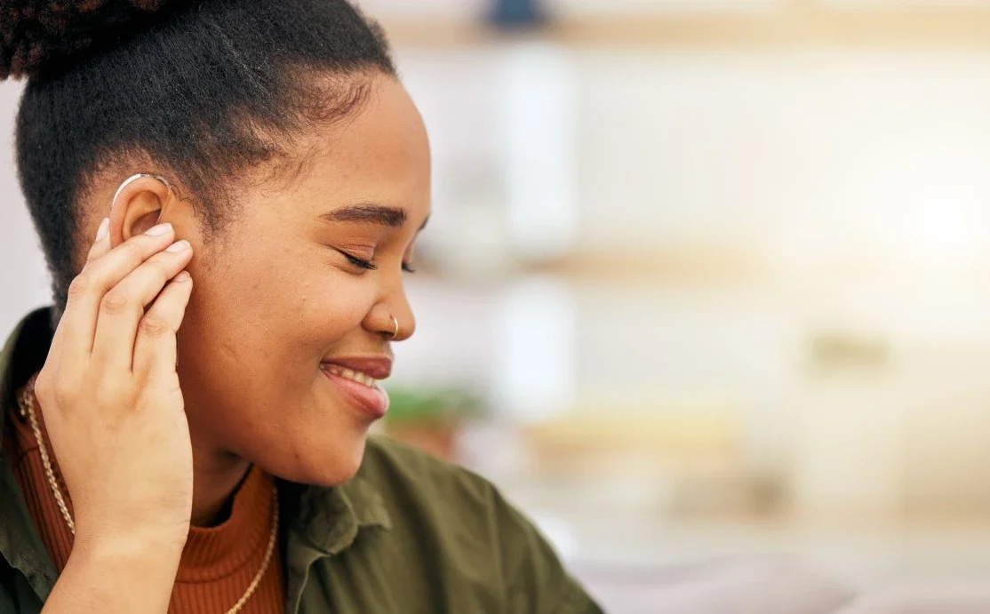 Deaf woman smiling and looking to the side